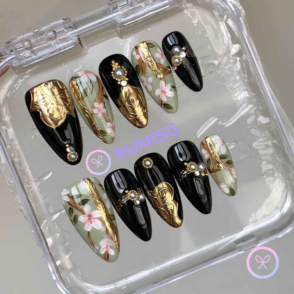 baroque black glossy medium almond press on nails with gold crest and cherry blossom