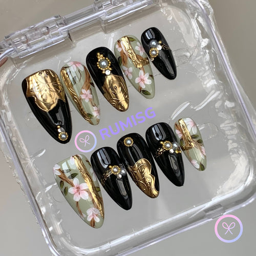 baroque black glossy medium almond press on nails with gold crest and cherry blossom