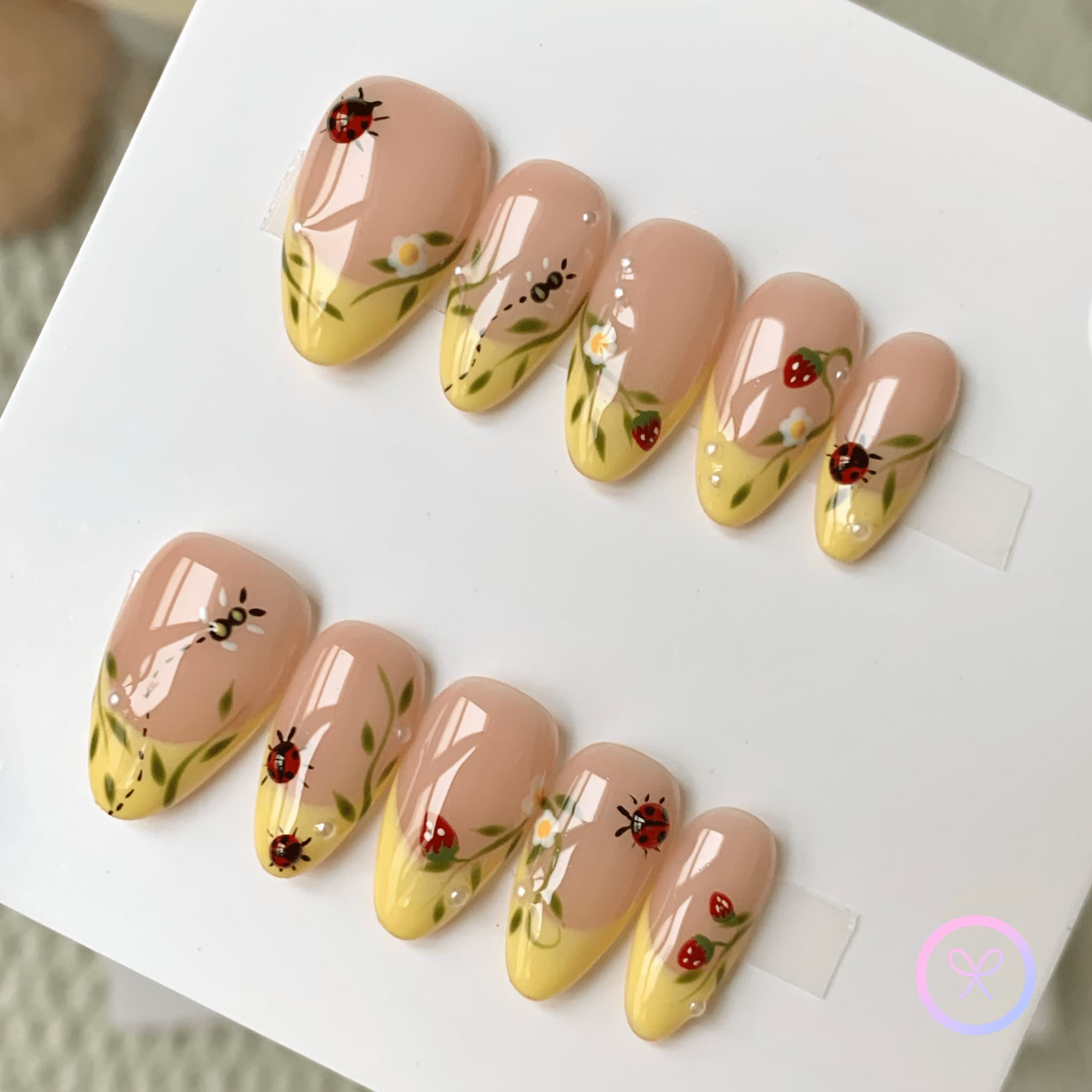 natural nude glossy short almond press on nails with ladybug and leaves and daisies