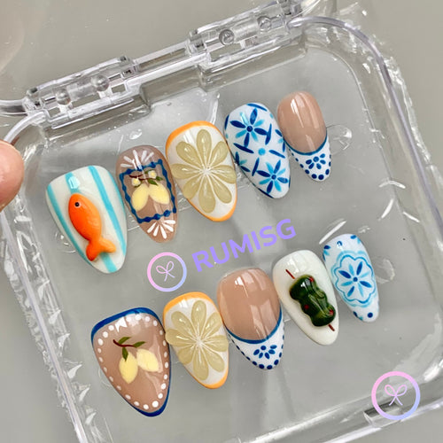amalfi coast yellow glossy short almond press on nails with lemon slice and mediterranean tile