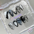 goth black glossy short almond press on nails with bloom scales and chrome swirls