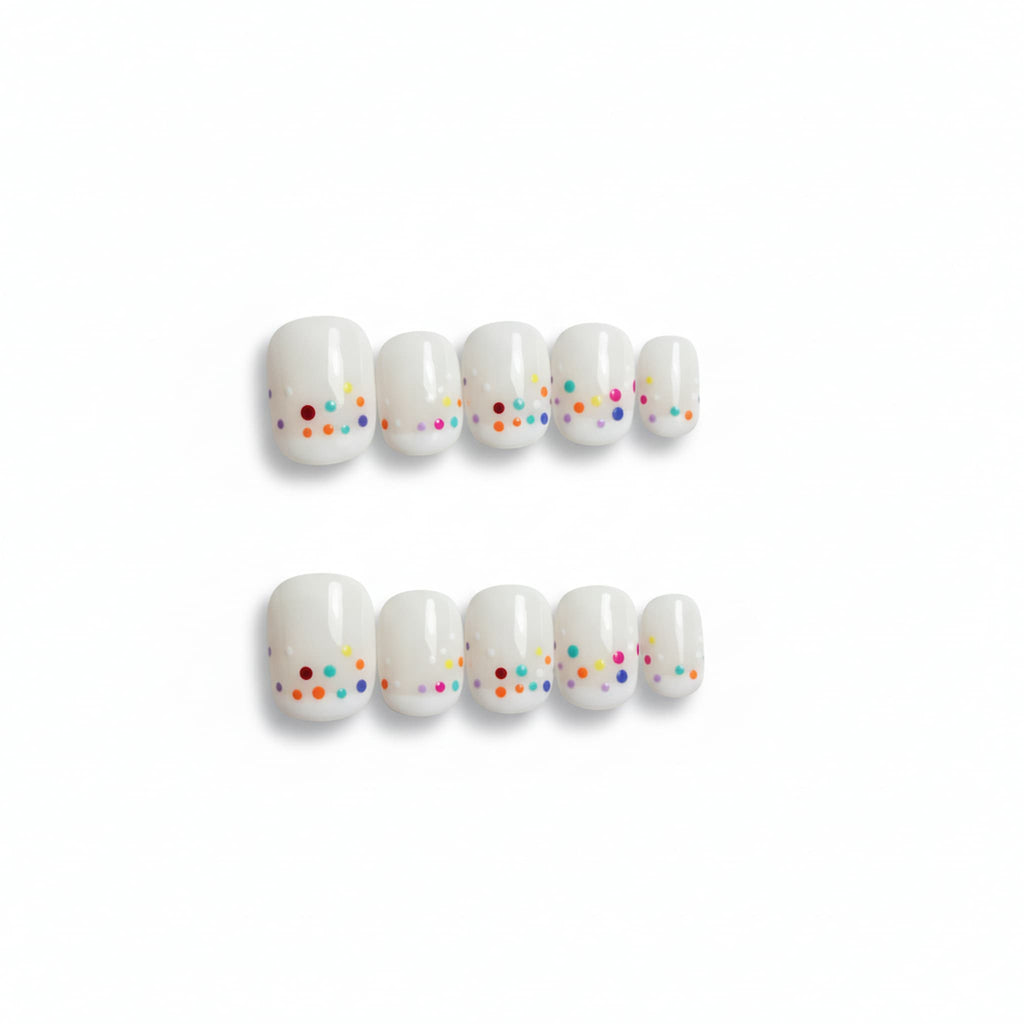 cute white glossy short round press on nails with confetti like dots , french tip