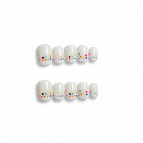 cute white glossy short round press on nails with confetti like dots , french tip