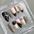 abstract black and nude glossy long stiletto press on nails with eye and stripe design