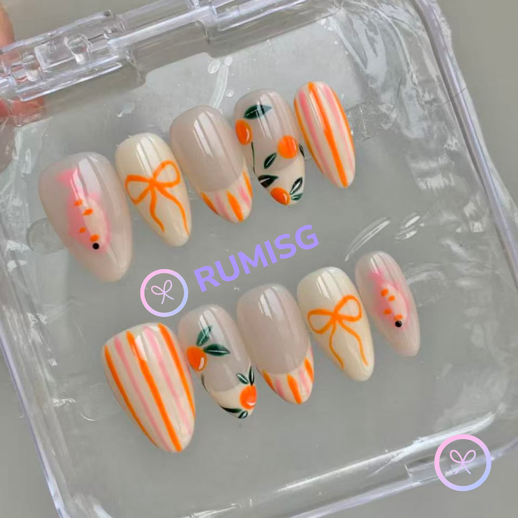 fruitcore orange glossy short almond press on nails with oranges, fish and bow motifs