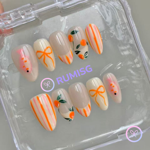 fruitcore orange glossy short almond press on nails with oranges, fish and bow motifs