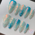 pearlcore blue pearlescent medium almond press on nails with pearls and mermaid tails