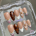 nude glossy medium almond press on nails with 3d flowers and tortoiseshell and swirls