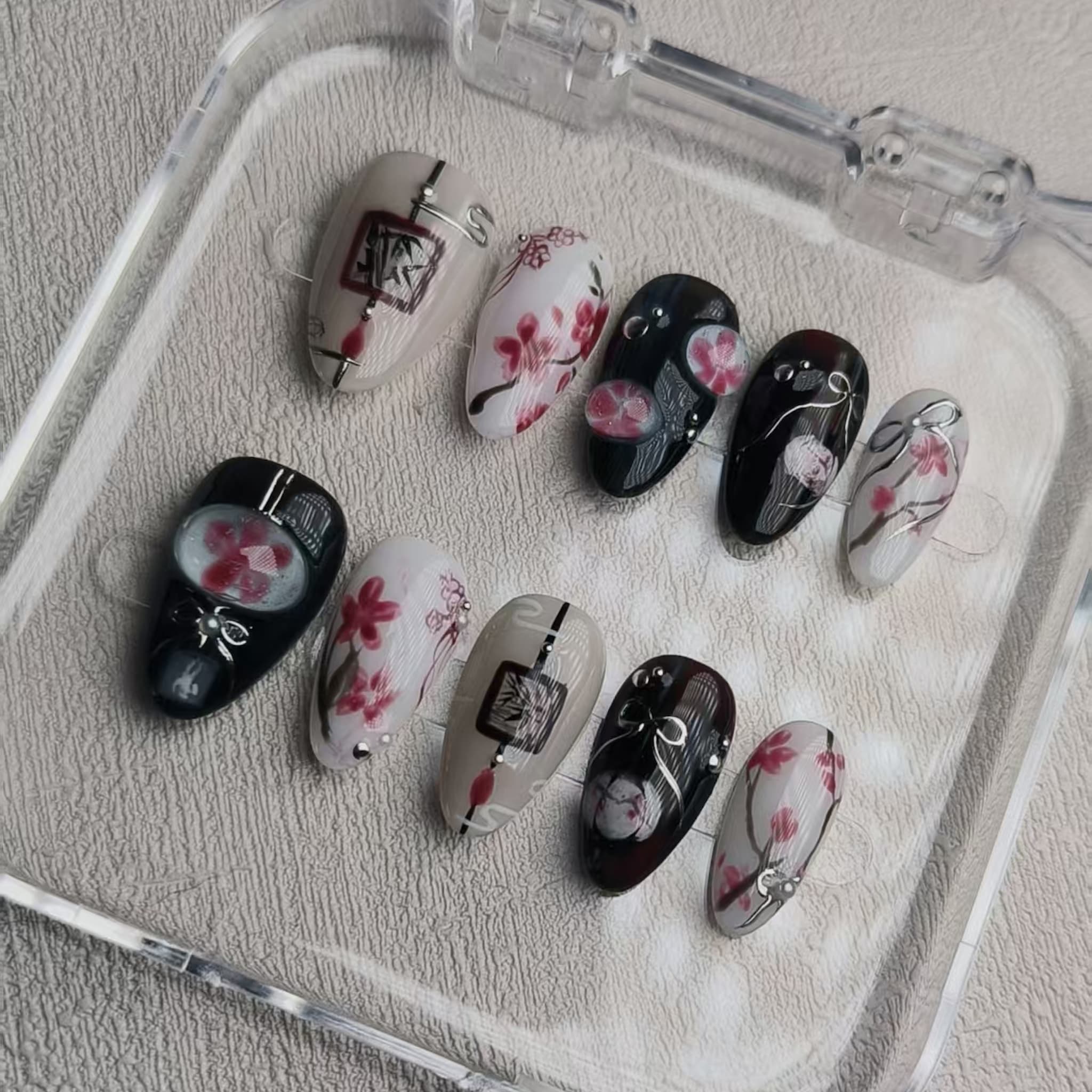 elegant black glossy short almond press on nails with sakura motifs and ink aesthetic