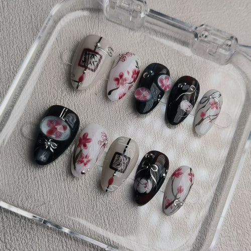 elegant black glossy short almond press on nails with sakura motifs and ink aesthetic