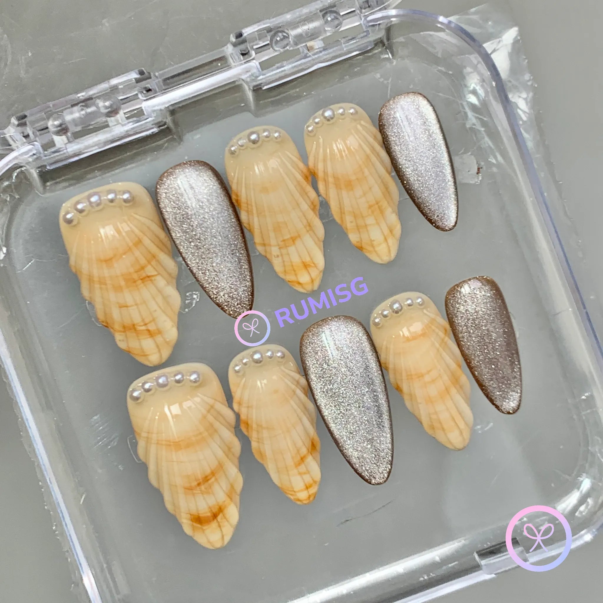 oceanic yellow glossy medium almond press on nails with sculpted seashell and pearl