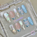 mermaidcore blue glossy medium oval press on nails with seashell and iridescent flake detail
