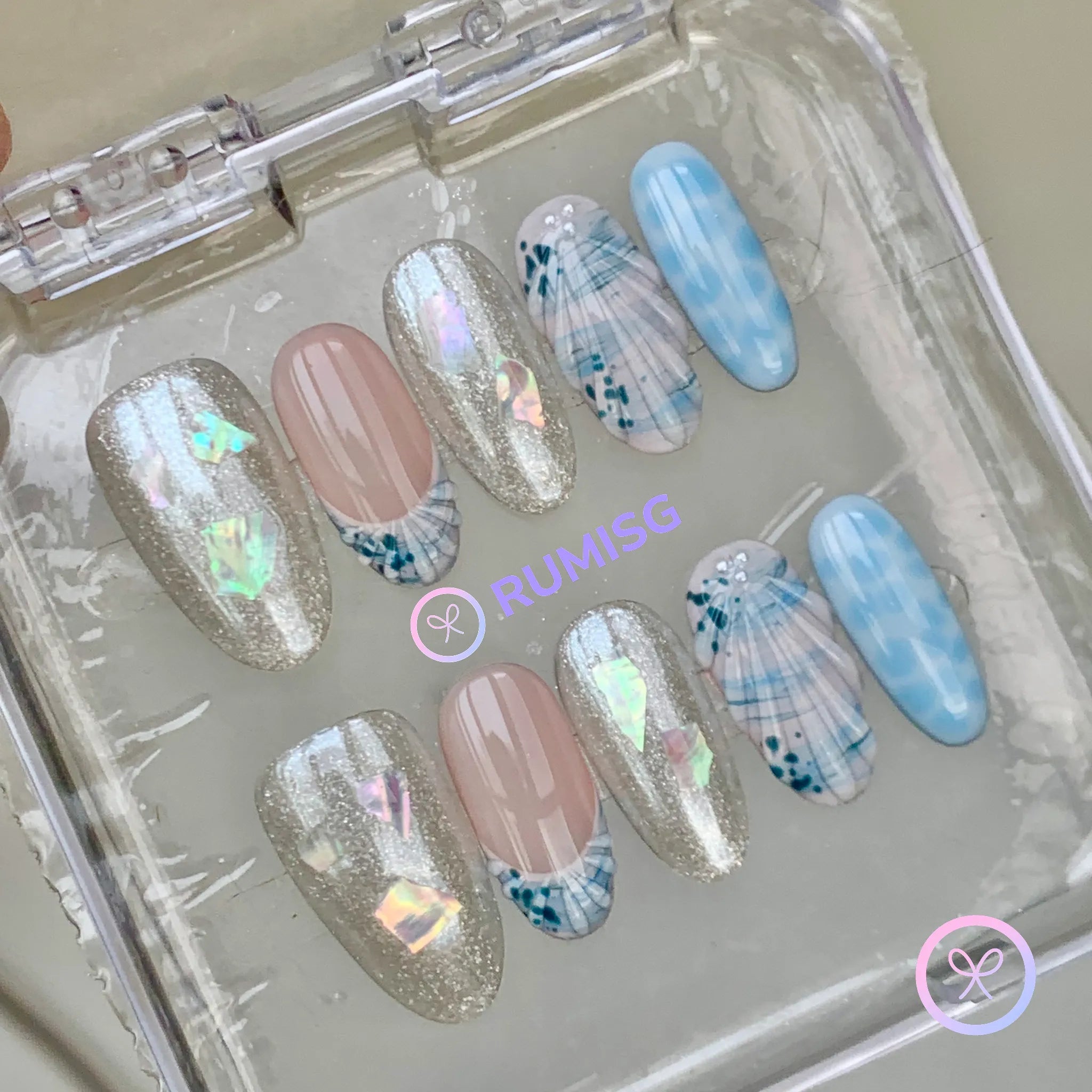mermaidcore blue glossy medium oval press on nails with seashell and iridescent flake detail