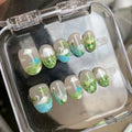 cottagecore green glossy short round press on nails with clouds and monet aesthetics