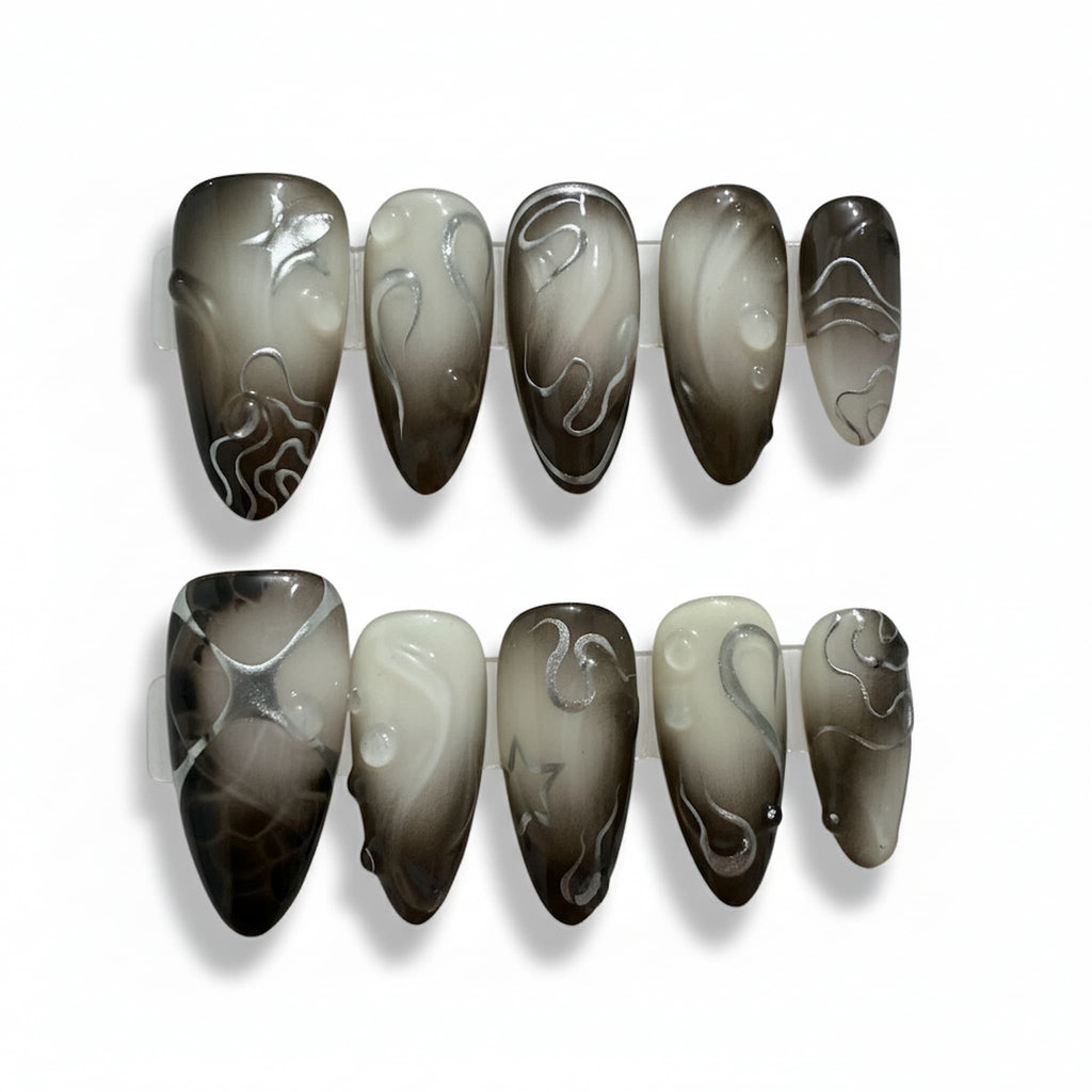 dark academia black glossy medium almond press on nails with contour lines and metallic stars and swirls