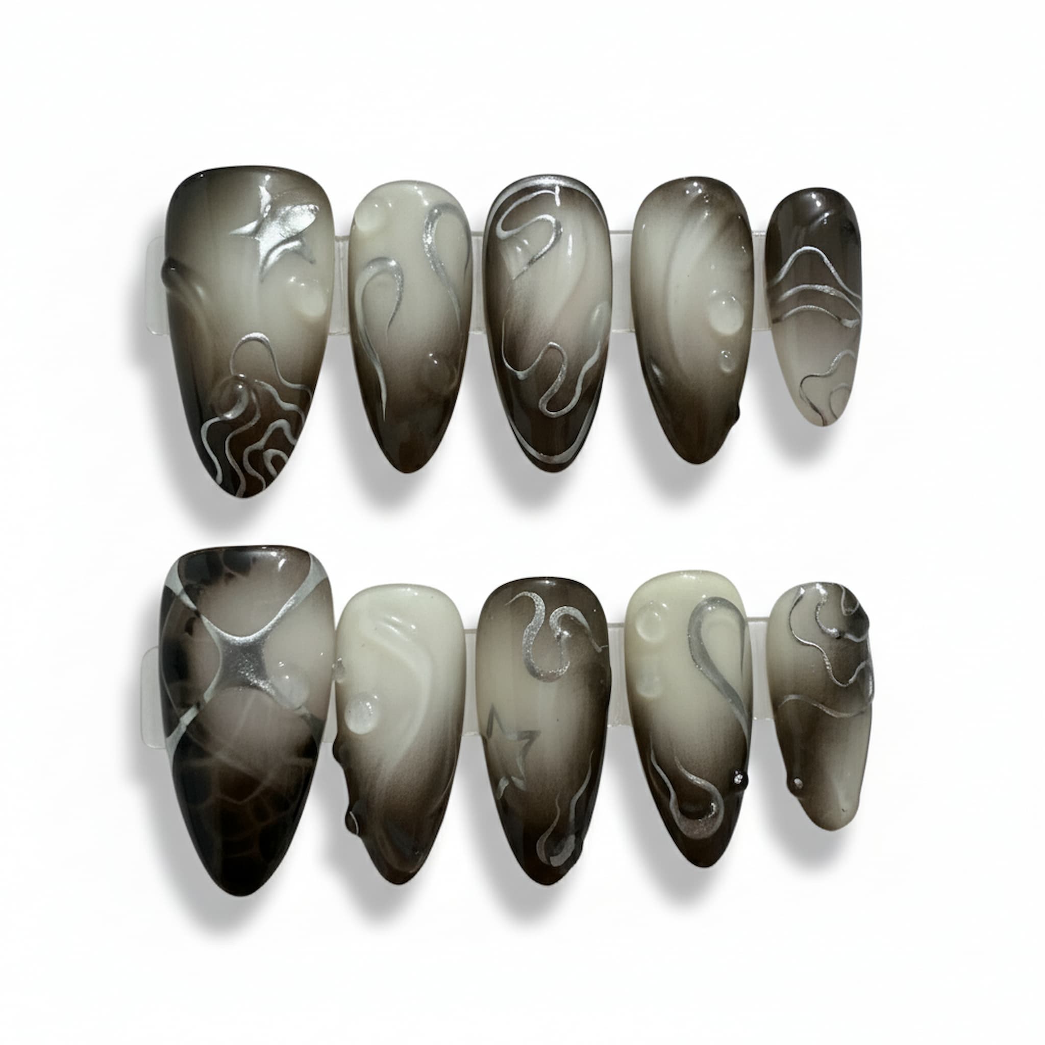 dark academia black glossy medium almond press on nails with contour lines and metallic stars and swirls