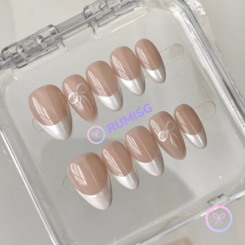  coquette nude glossy short almond press on nails with french tip and drawn bow