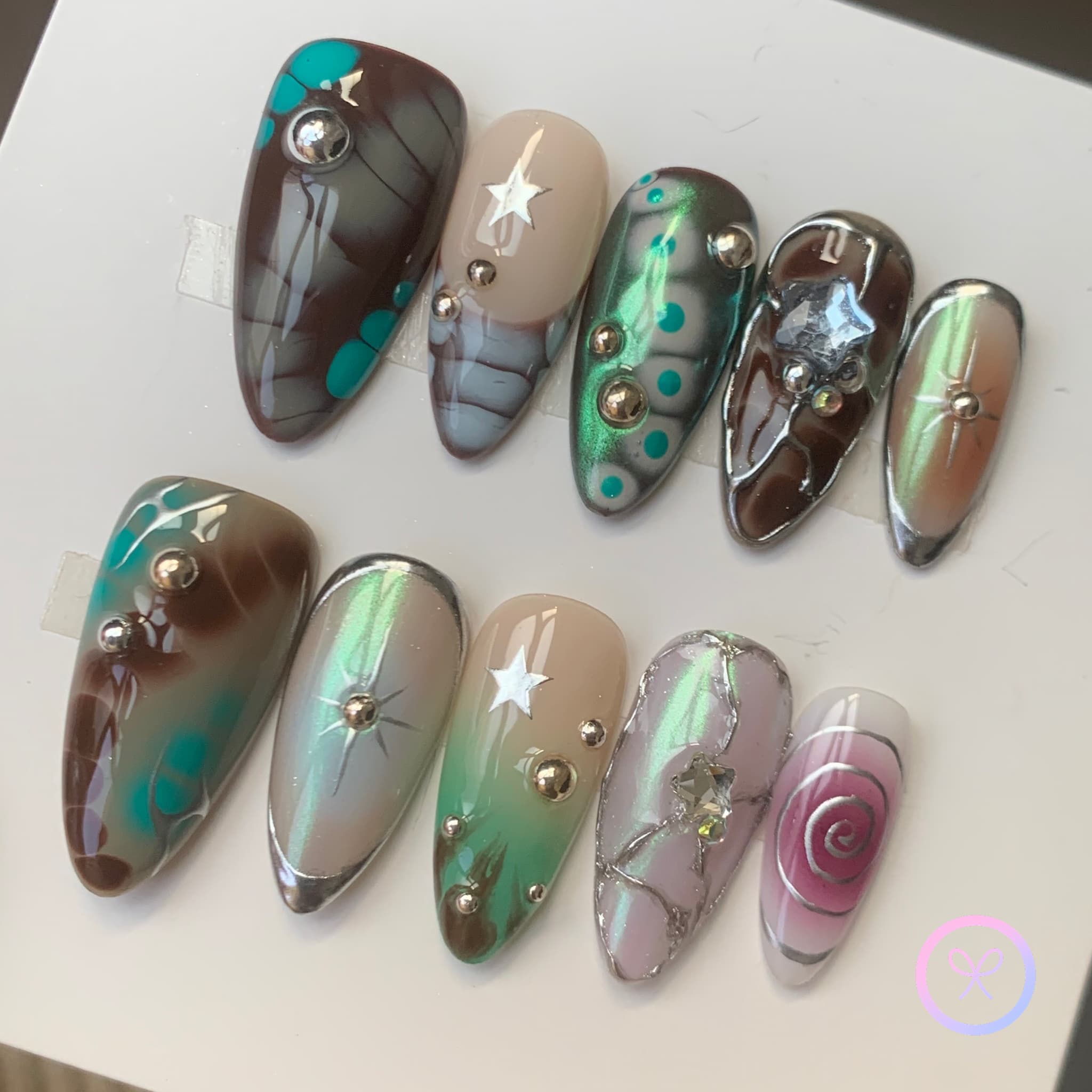celestial green glossy medium almond press on nails with eyes and bloomscales and spiral