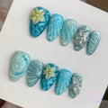oceanic blue glossy short almond press on nails with water ripple effect and embossed flowers
