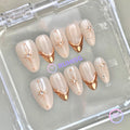 elegant nude glossy short almond press on nails with gold french tip and gold star burst