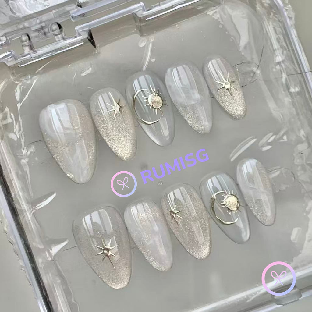 celestial silver glossy short almond press on nails with starburst and sun motifs