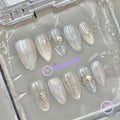 celestial silver glossy short almond press on nails with starburst and sun motifs