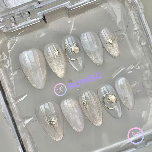 celestial silver glossy short almond press on nails with starburst and sun motifs
