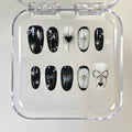 gothic black glossy short oval press on nails with hearts and celestial motifs