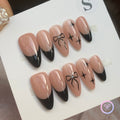 minimalist nude glossy medium almond press on nails with black bows and star motifs