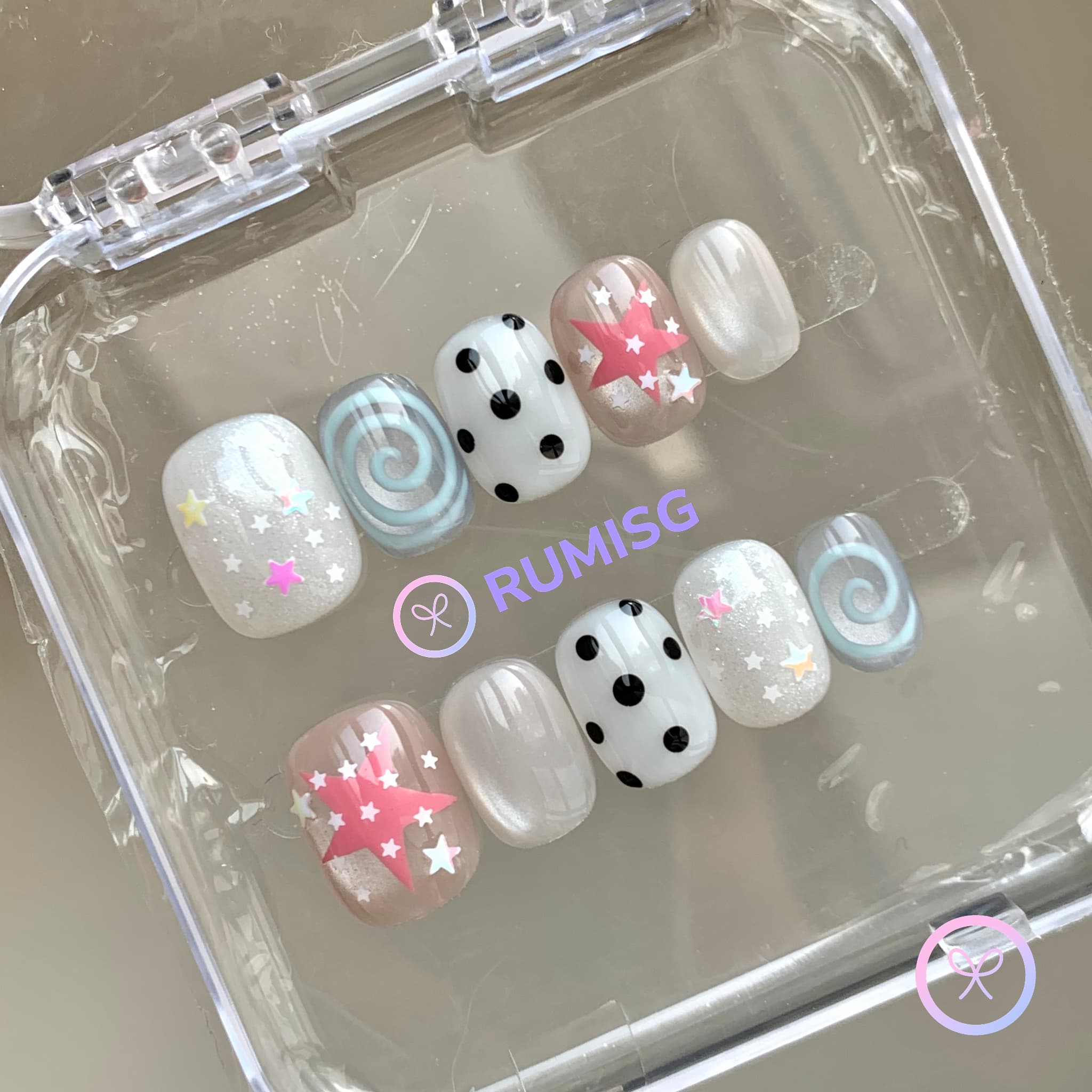 y2k white glossy short round press on nails with pink star and cyan swirl