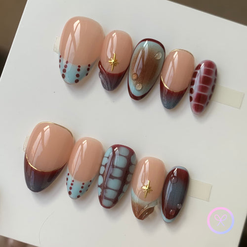 abstract nude glossy short almond press on nails with dot linework , bloom scales and star charms