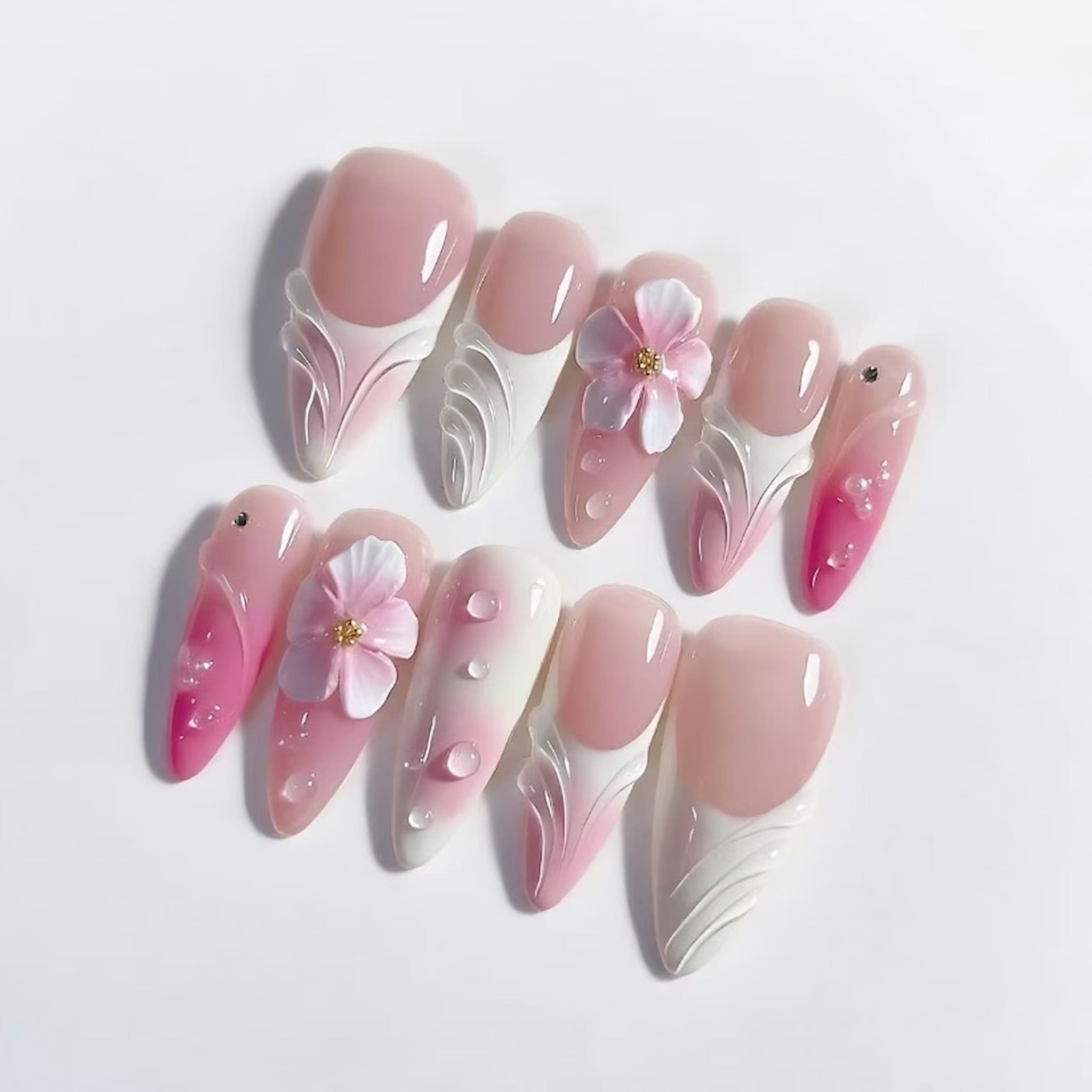 Set of pink and white floral nail art designs 
