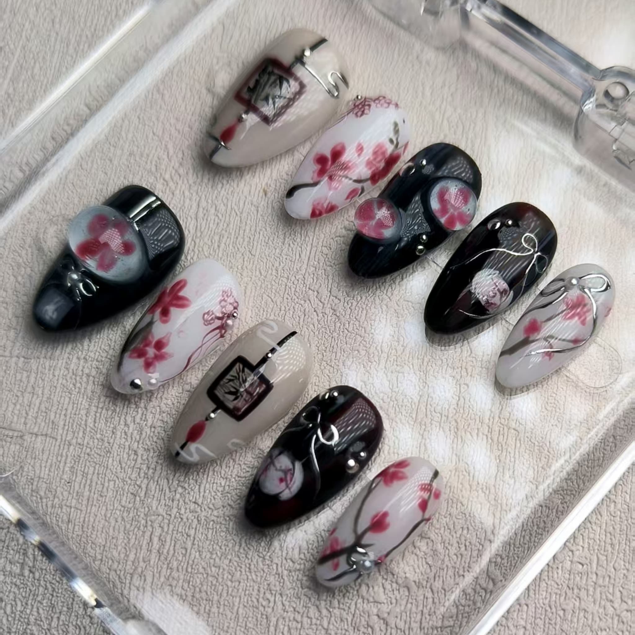 elegant black glossy short almond press on nails with sakura motifs and ink aesthetic