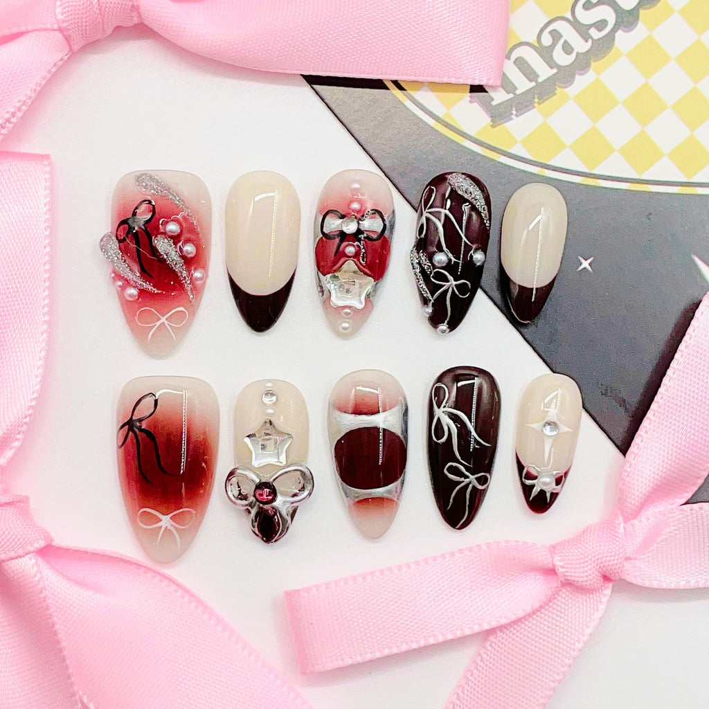 Decorative nail art with red, white, and black designs