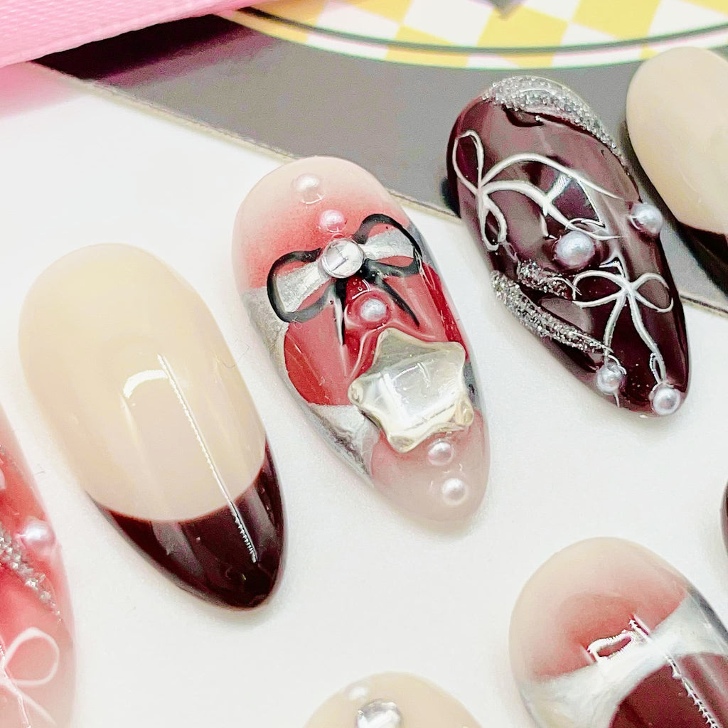 Decorative nail art with red, white, and black designs