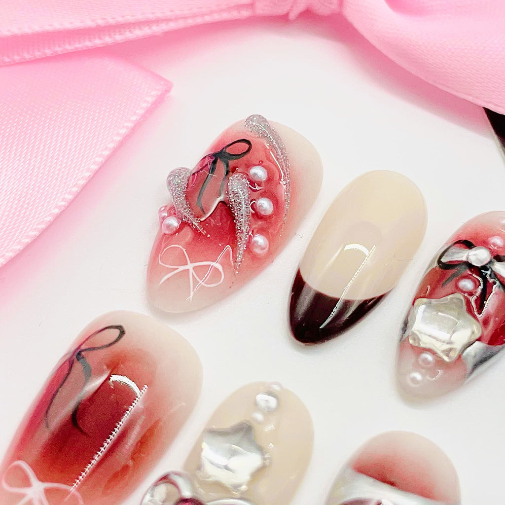 Decorative nail art with red, white, and black designs