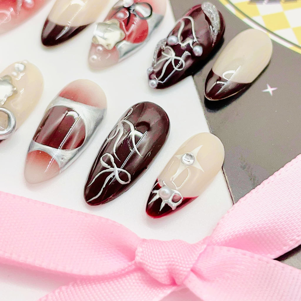 Decorative nail art with red, white, and black designs