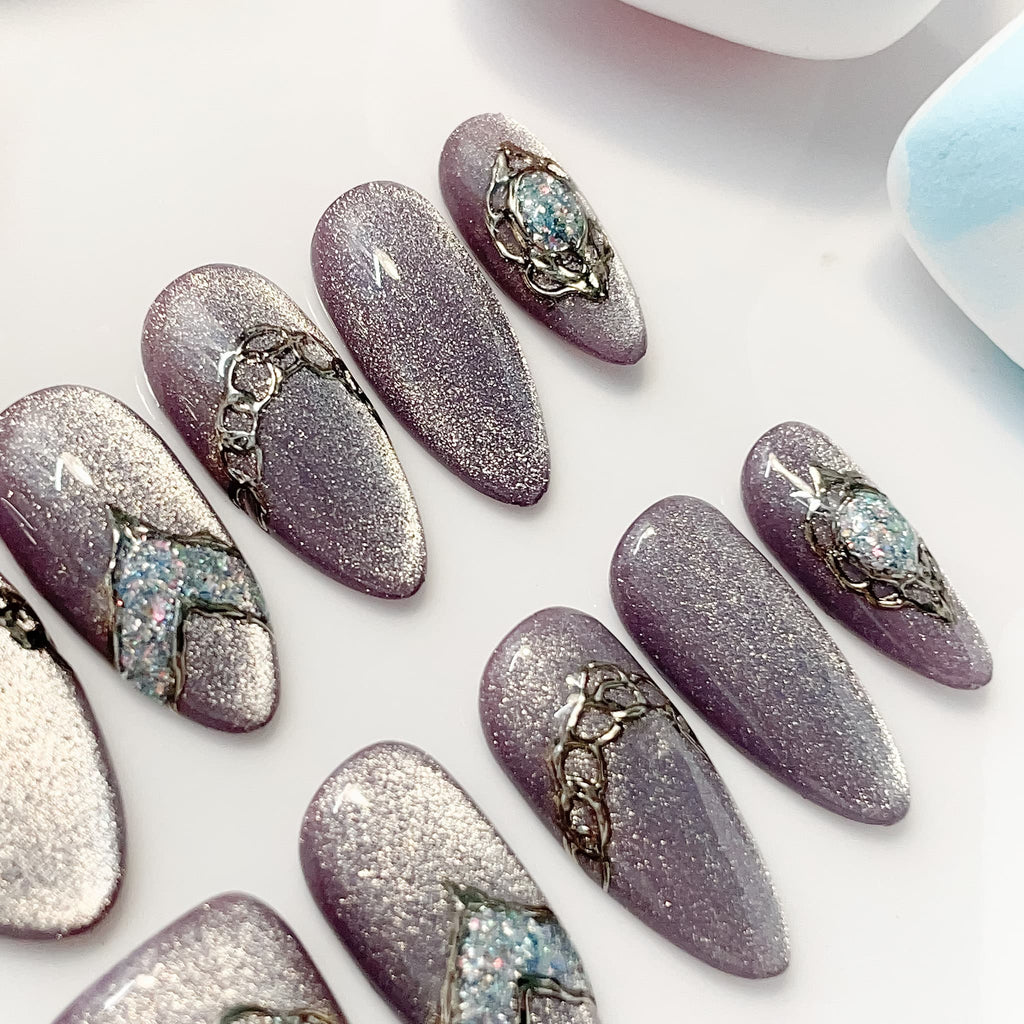 medium length lavender almond press on nails with glitter design