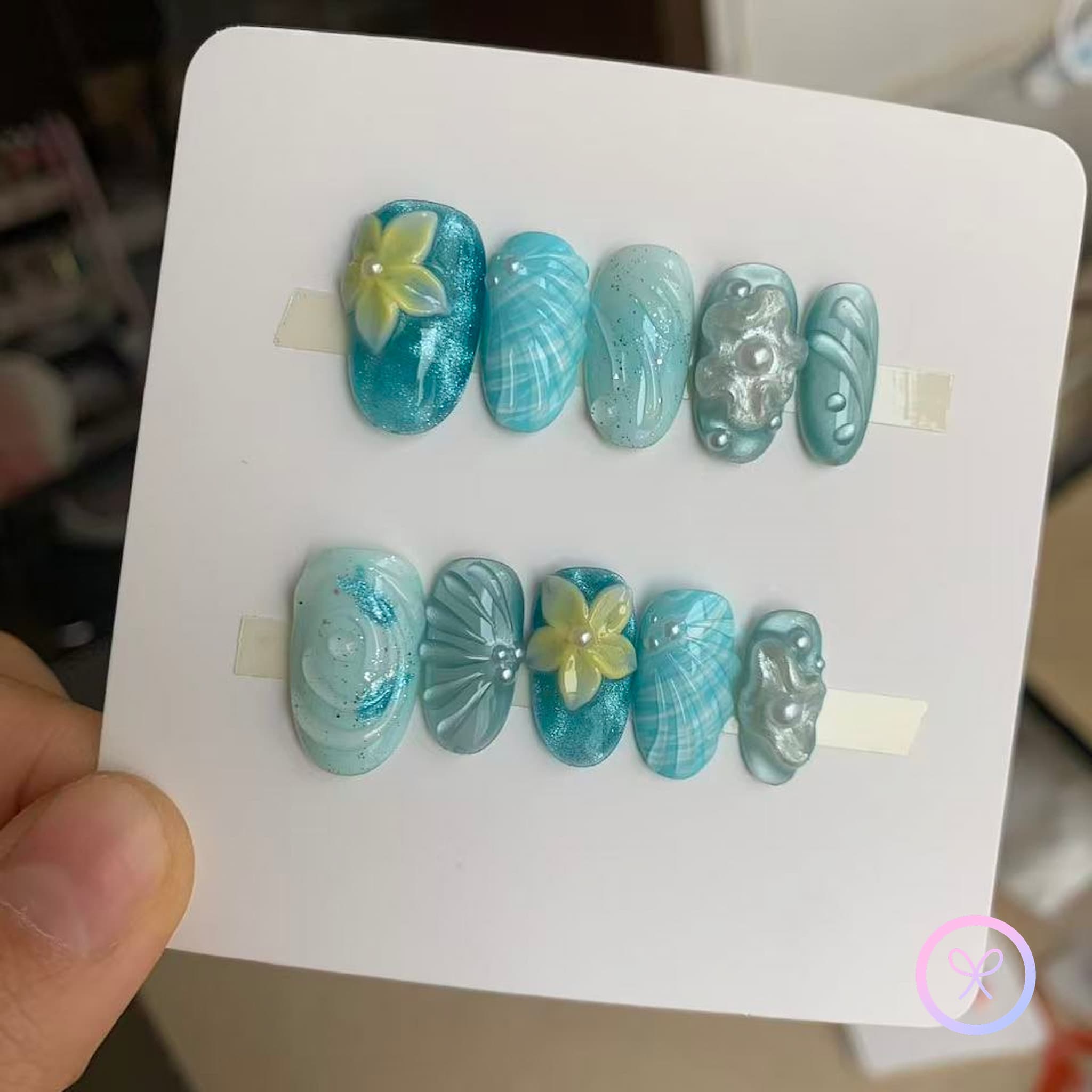 oceanic blue glossy short oval press on nails with water ripple effect and embossed flowers