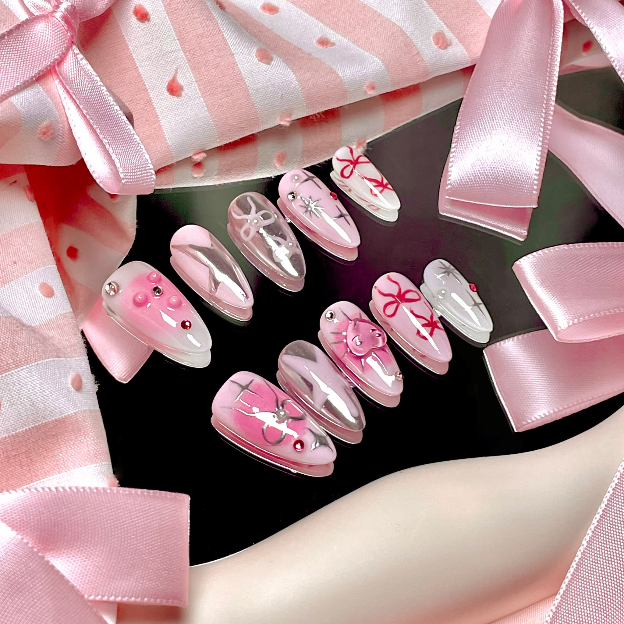 medium length light pink almond press on nails with stars and bows design