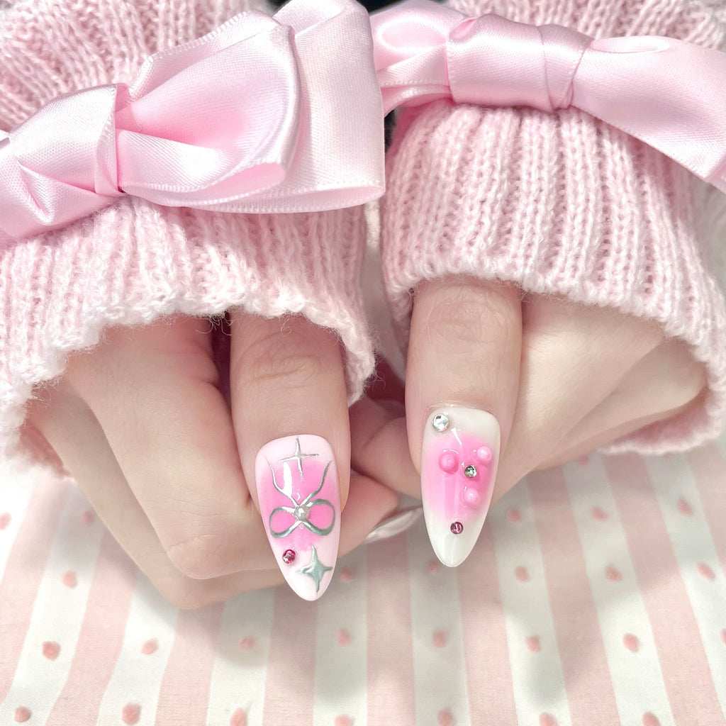 medium length light pink almond press on nails with stars and bows design