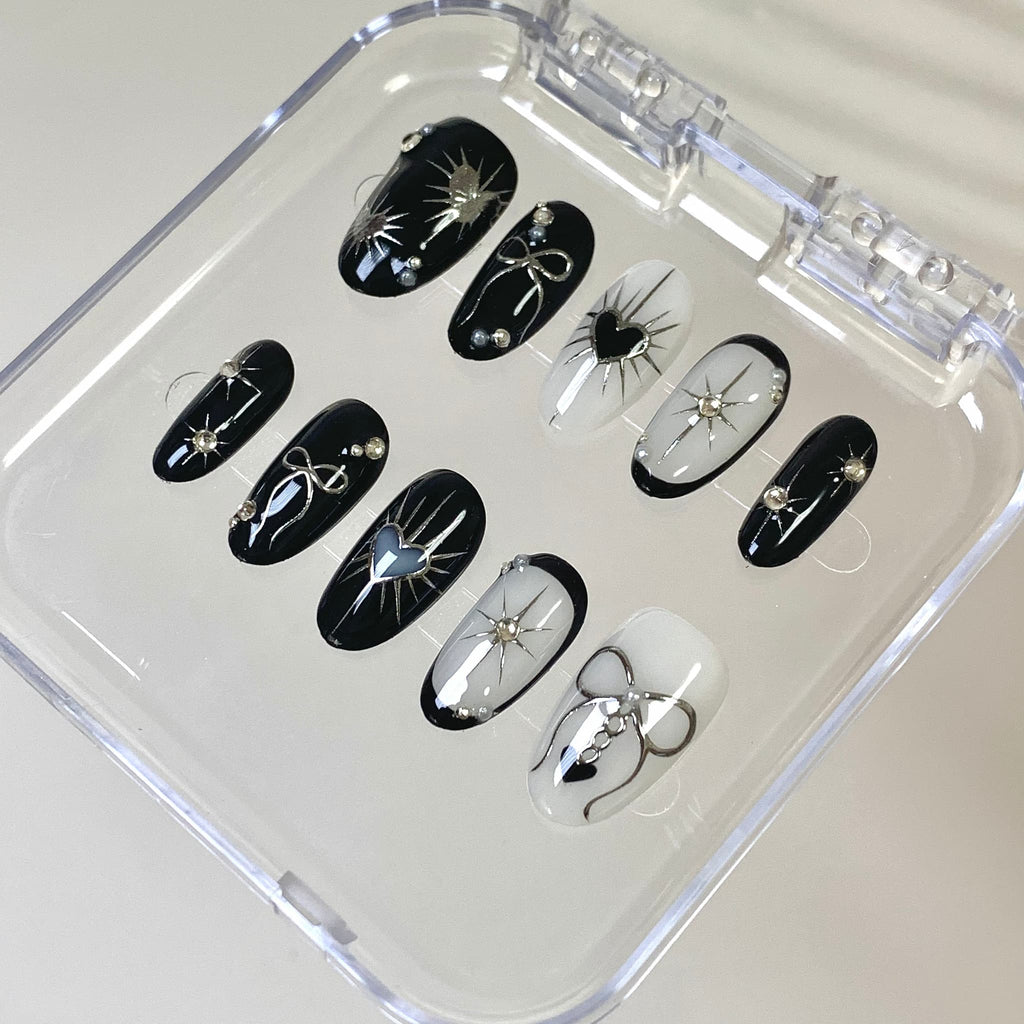 gothic black glossy short oval press on nails with hearts and celestial motifs