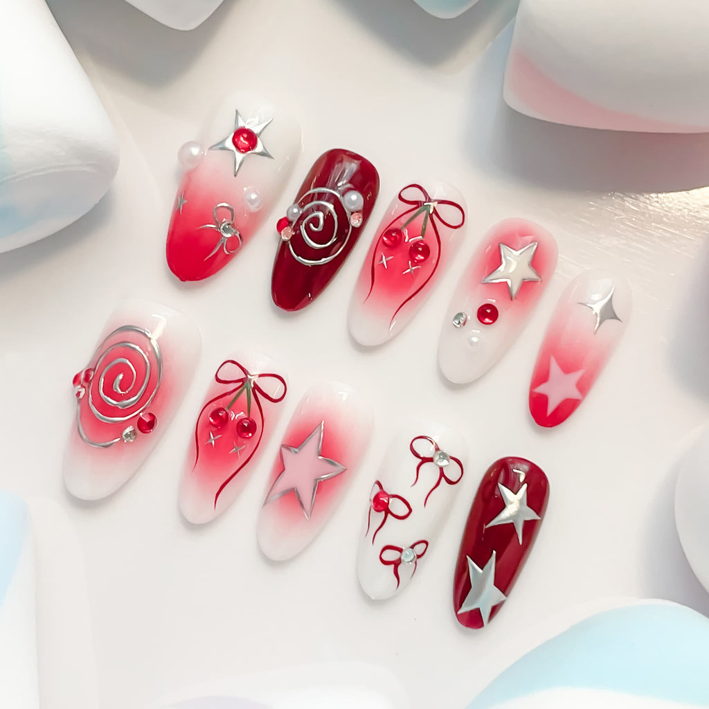 medium length crimson oval press on nails with spiral/star and cherries design