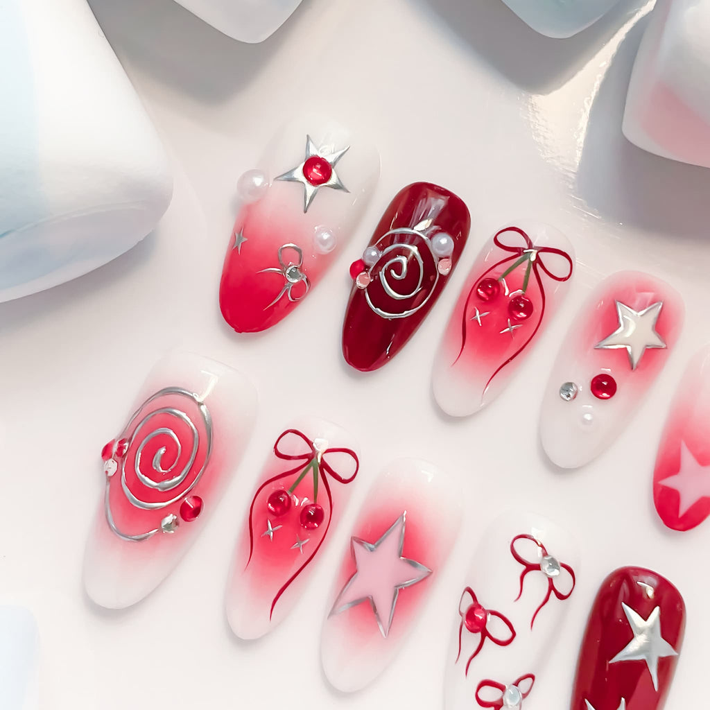 medium length crimson oval press on nails with spiral/star and cherries design