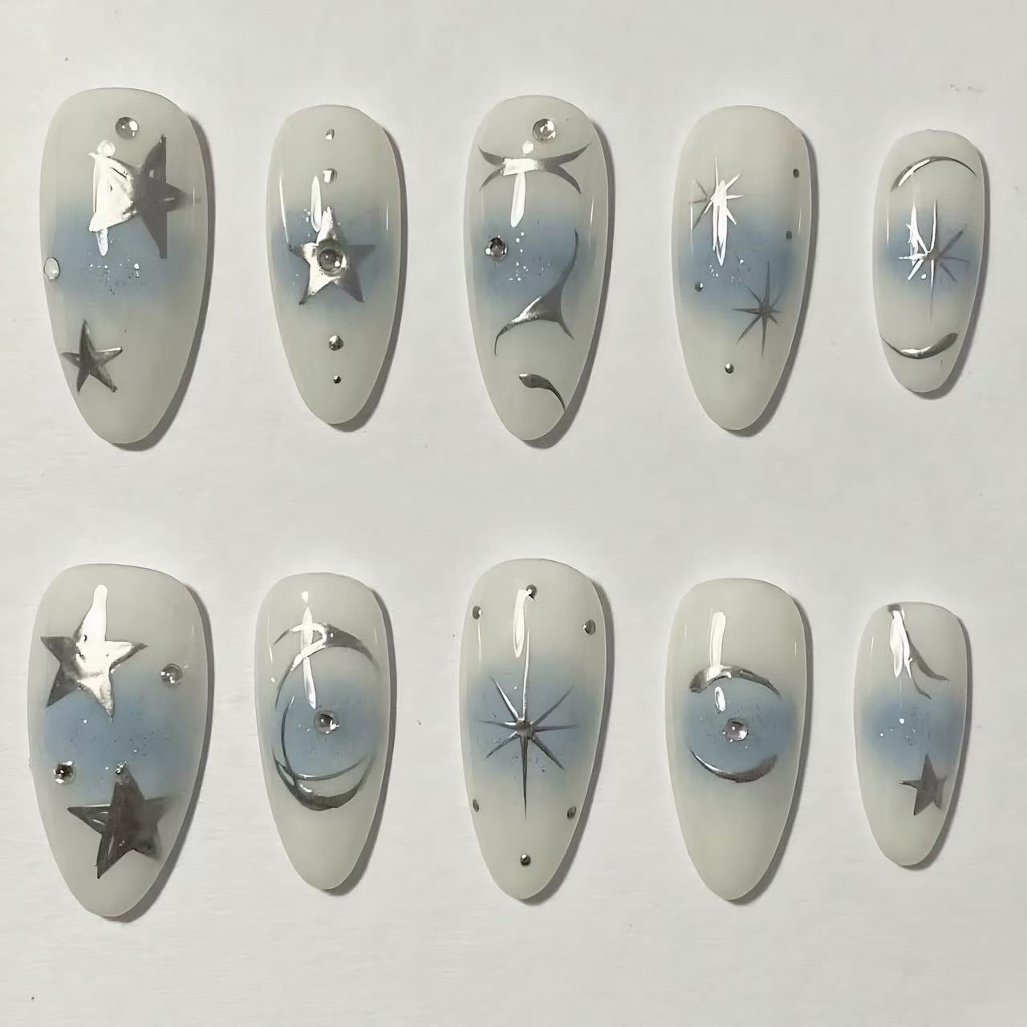 medium length white almond press on nails with star designs