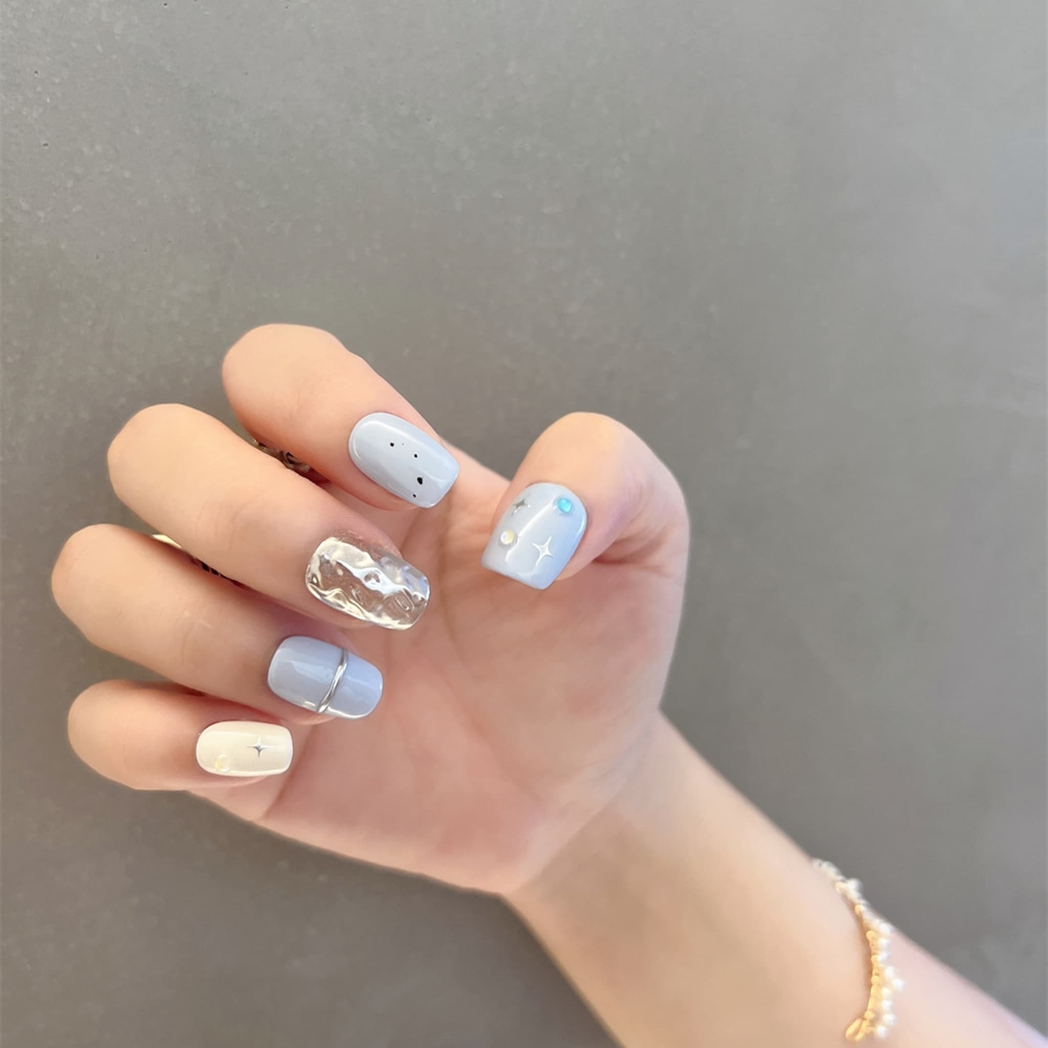 short length light blue squoval press on nails with star patterns