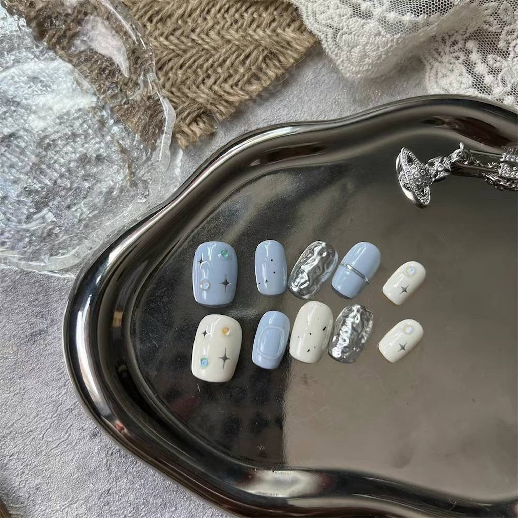 short length light blue squoval press on nails with star patterns