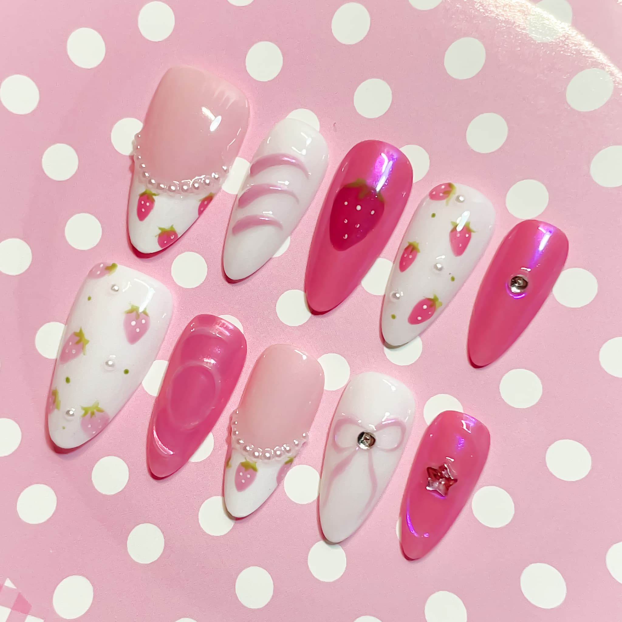 medium length pink almond press on nails with strawberry design