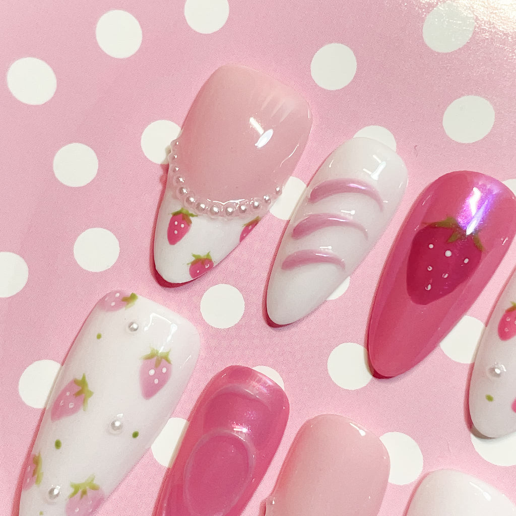medium length pink almond press on nails with strawberry design