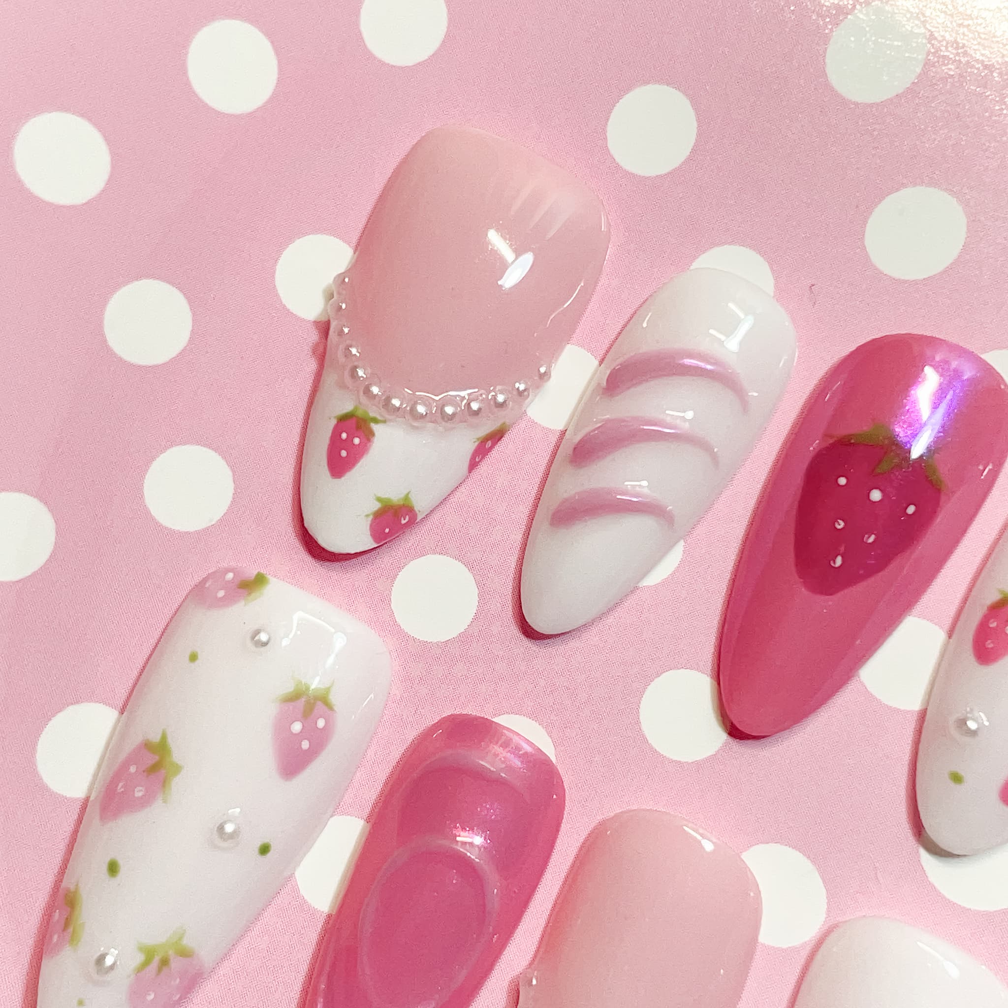 medium length pink almond press on nails with strawberry design